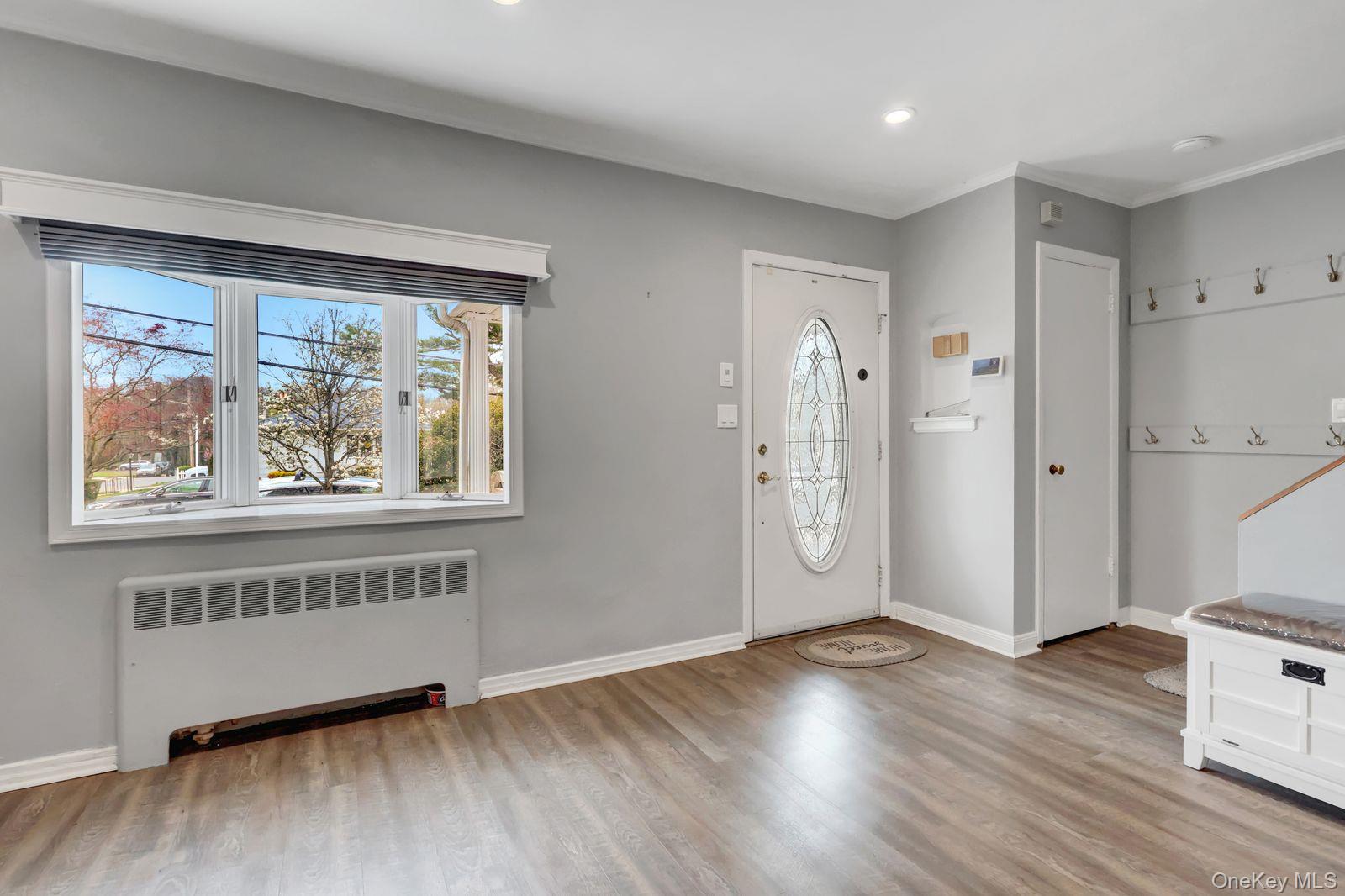 451 North Grove Street Valley Stream, NY 11580 - Photo 12 of 38 a view of an empty room with wooden floor and a window