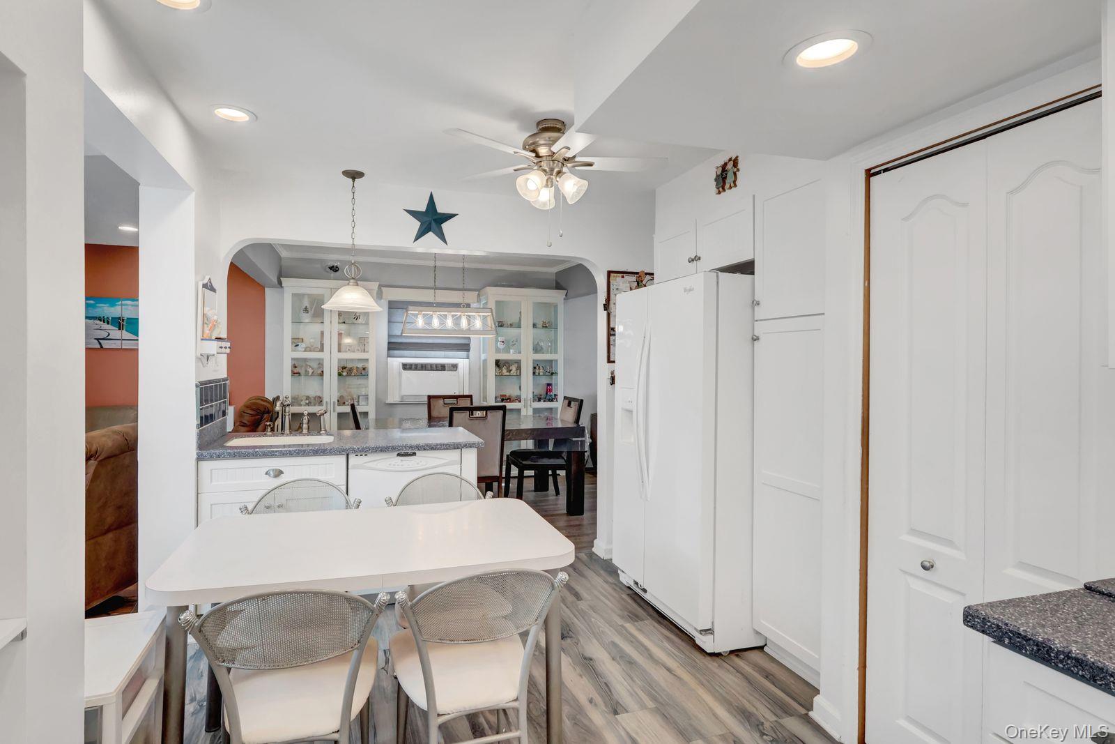 451 North Grove Street Valley Stream, NY 11580 - Photo 20 of 38 a kitchen with stainless steel appliances a dining table chairs and chandelier
