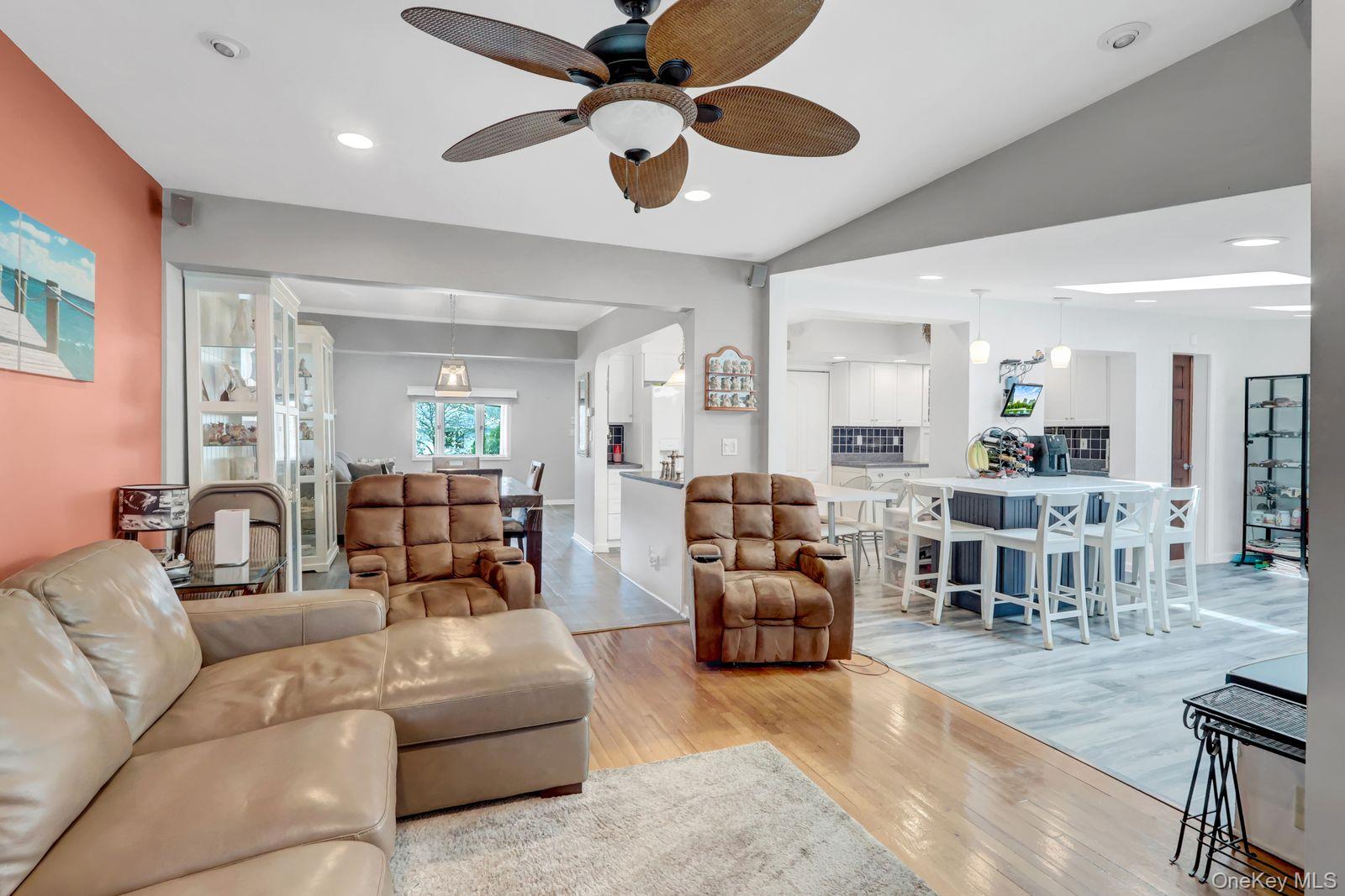 451 North Grove Street Valley Stream, NY 11580 - Photo 22 of 38 a living room with furniture kitchen view and a chandelier