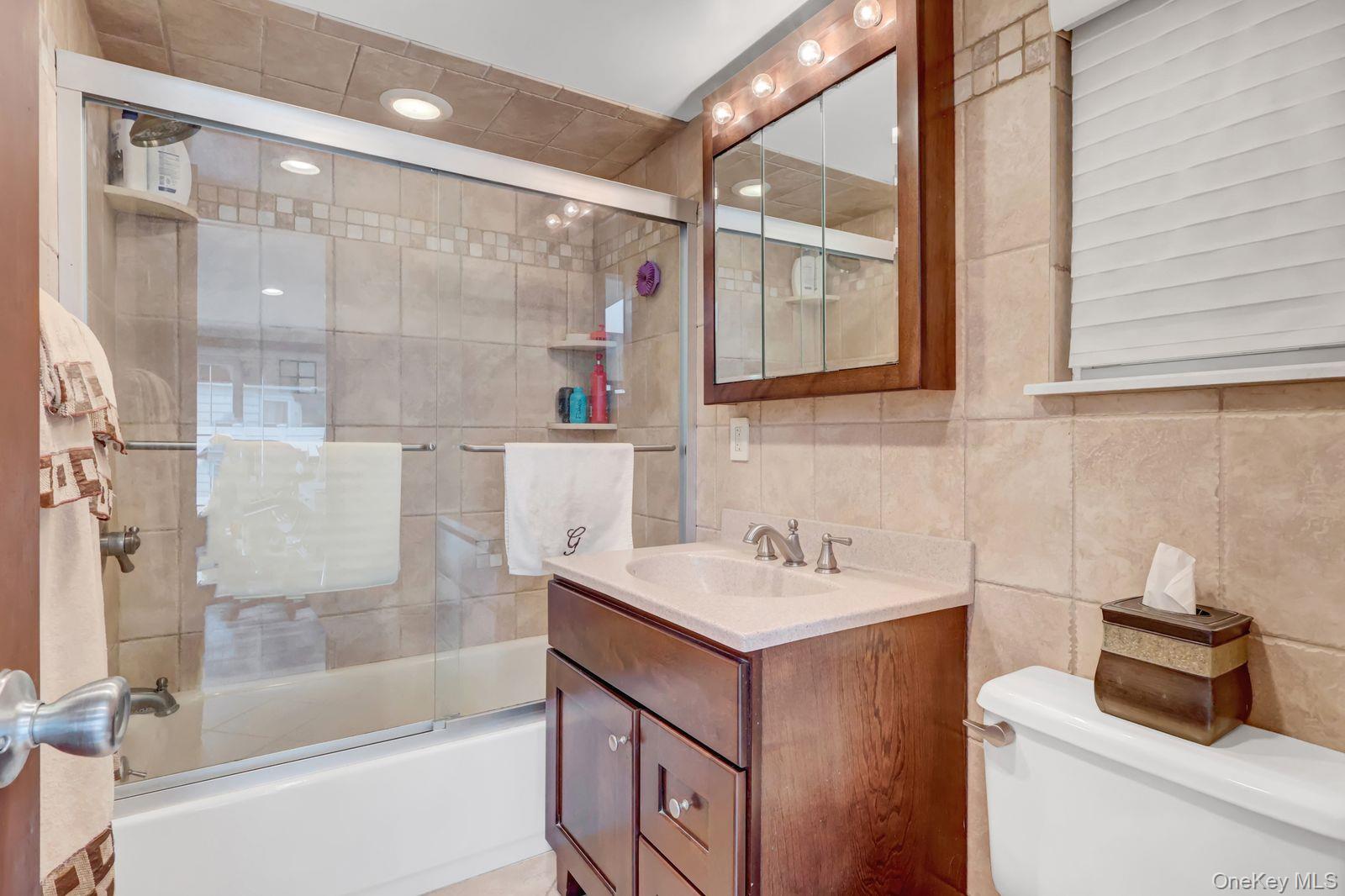 451 North Grove Street Valley Stream, NY 11580 - Photo 25 of 38 a bathroom with a sink and a mirror