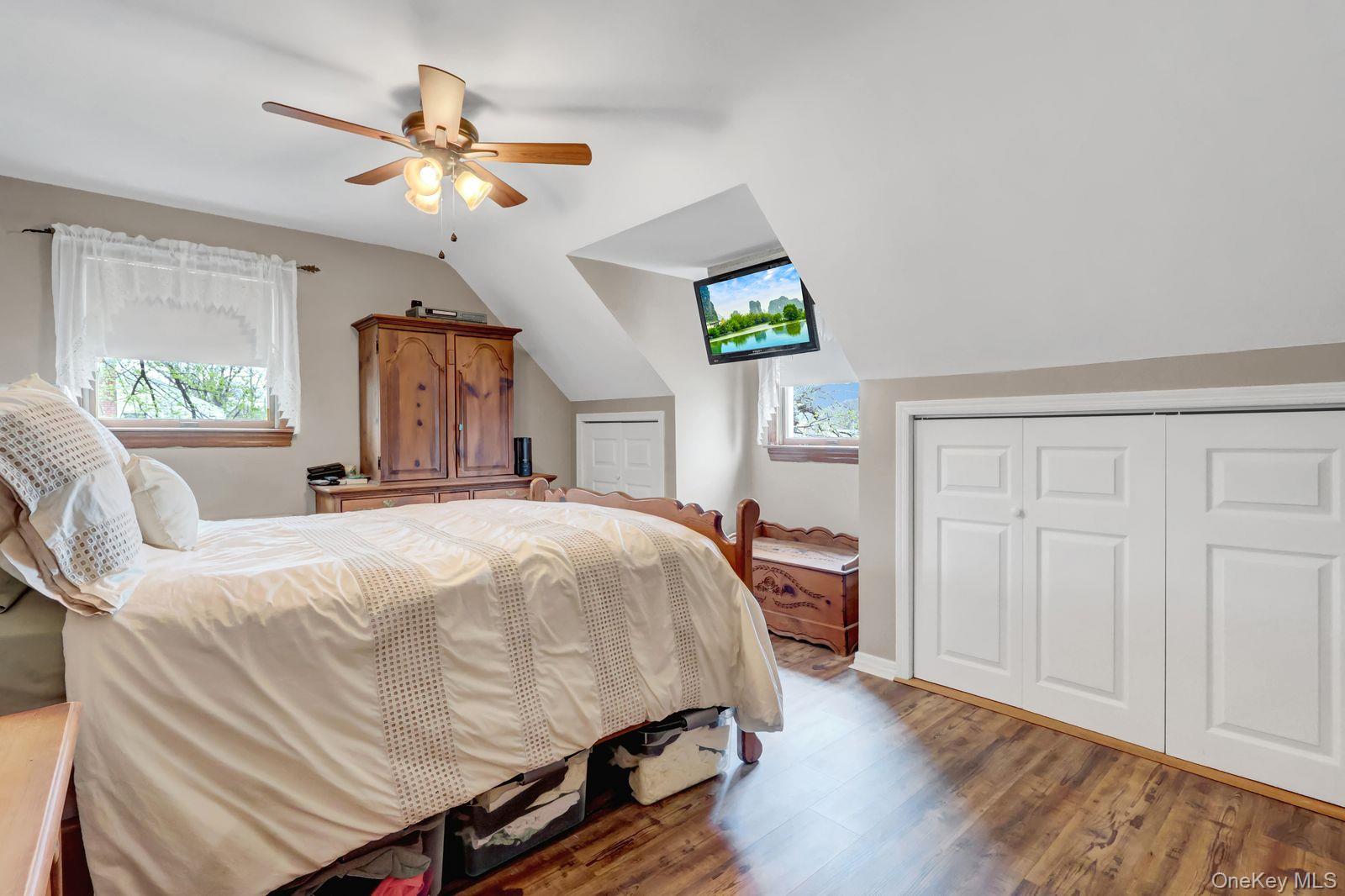 451 North Grove Street Valley Stream, NY 11580 - Photo 28 of 38 a bed room with a bed and a chandelier
