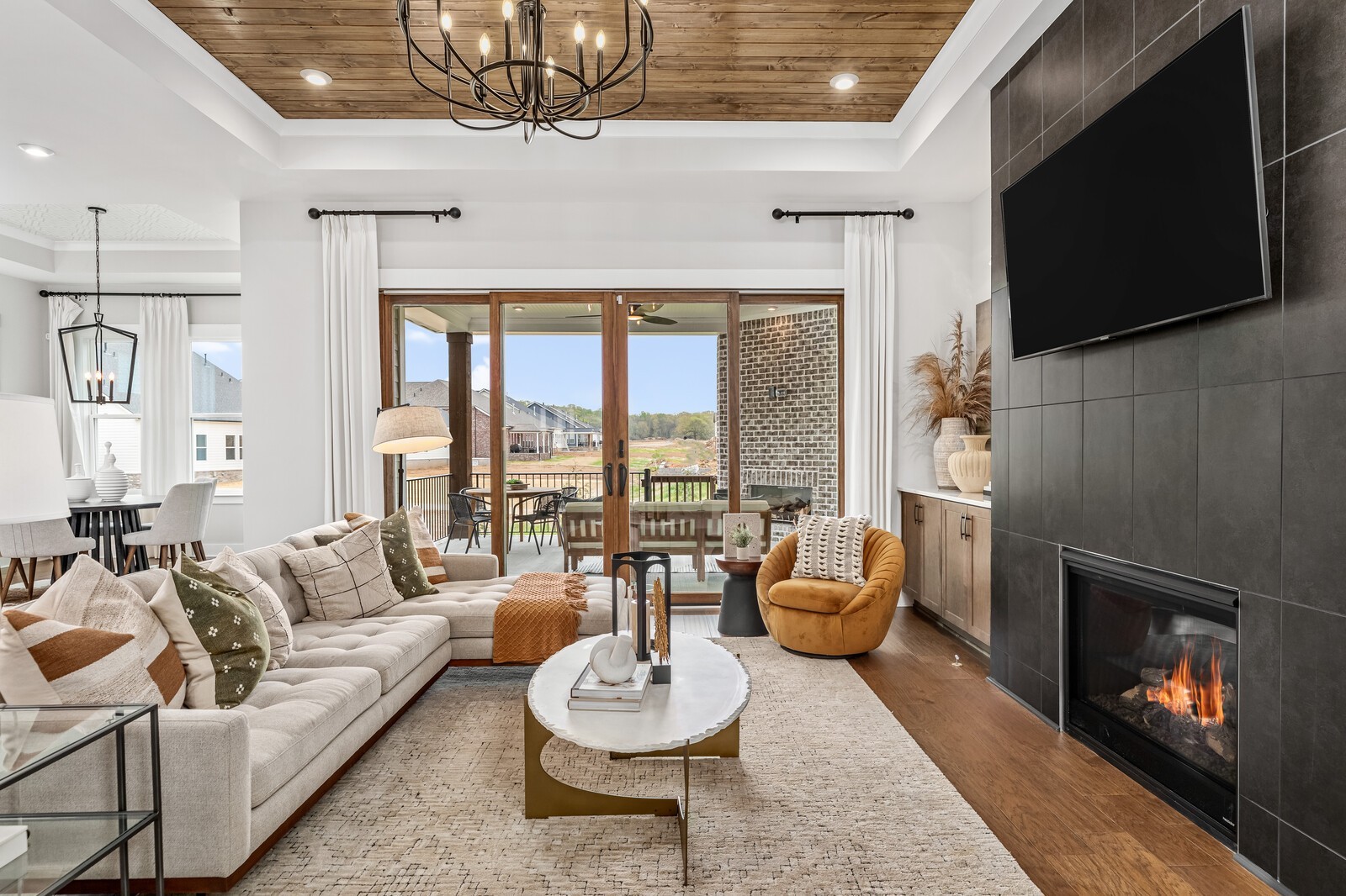4740 Ash Hill Road Spring Hill, TN 37174 - Photo 20 of 82 a living room with furniture a flat screen tv and a fireplace