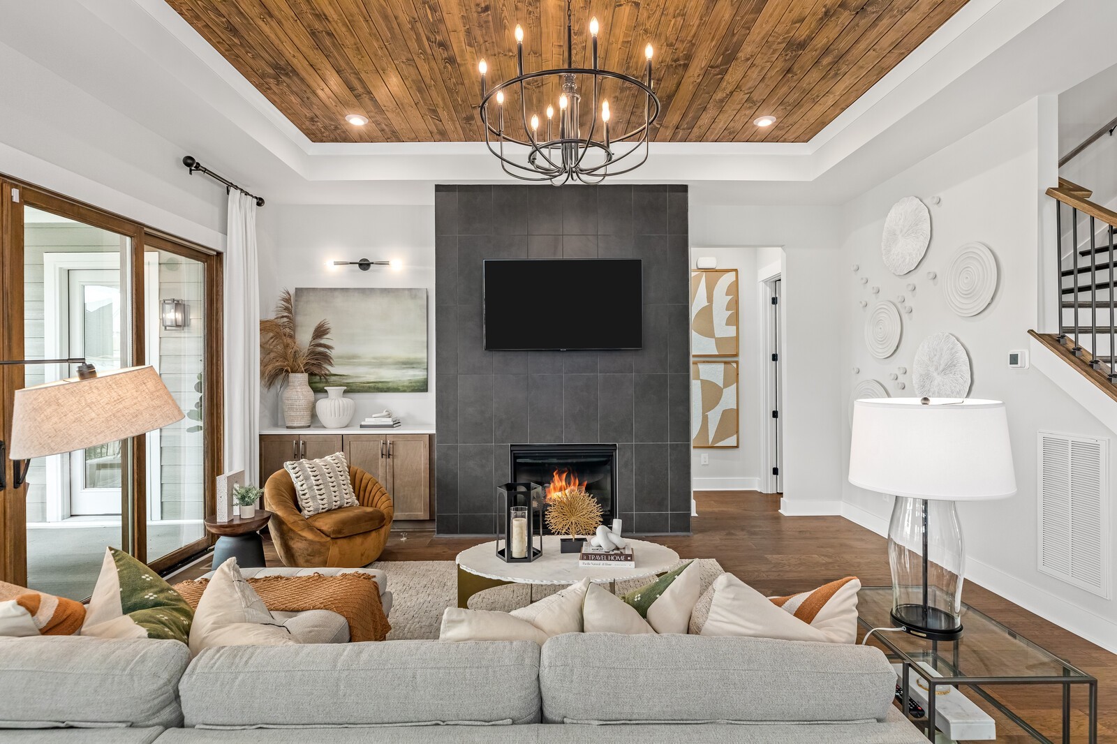 4740 Ash Hill Road Spring Hill, TN 37174 - Photo 21 of 82 a living room with furniture a chandelier and a fireplace