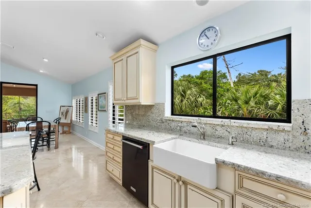 a kitchen with stainless steel appliances granite countertop sink stove and cabinets