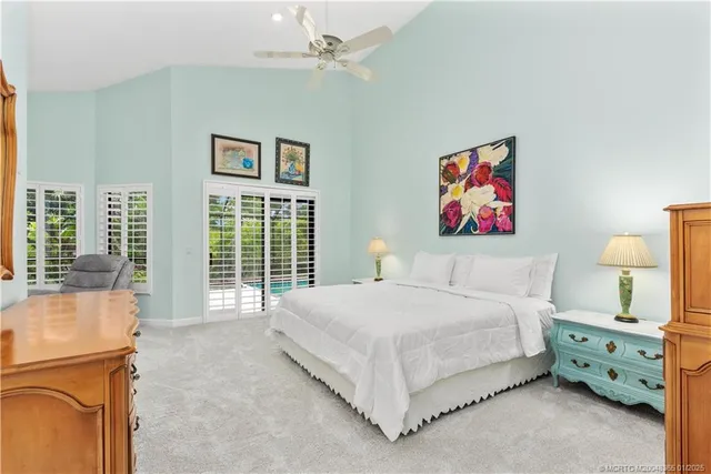 a spacious bedroom with a bed a couch and a window