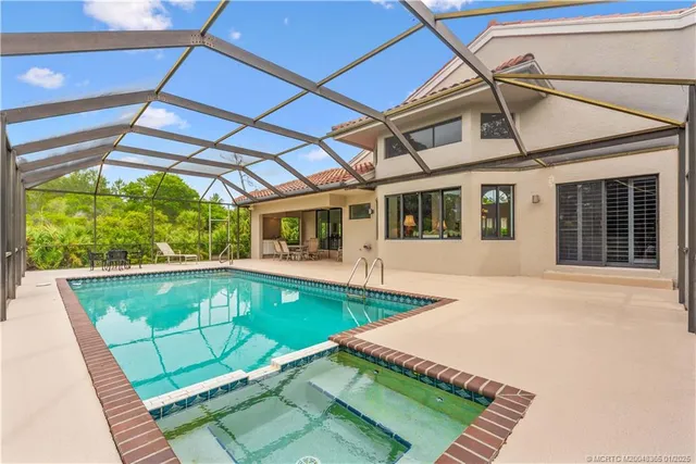 a view of a backyard with a swimming pool