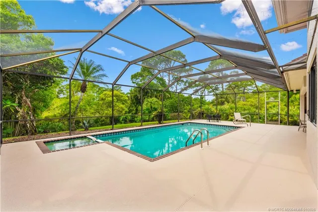 a view of a swimming pool with a yard