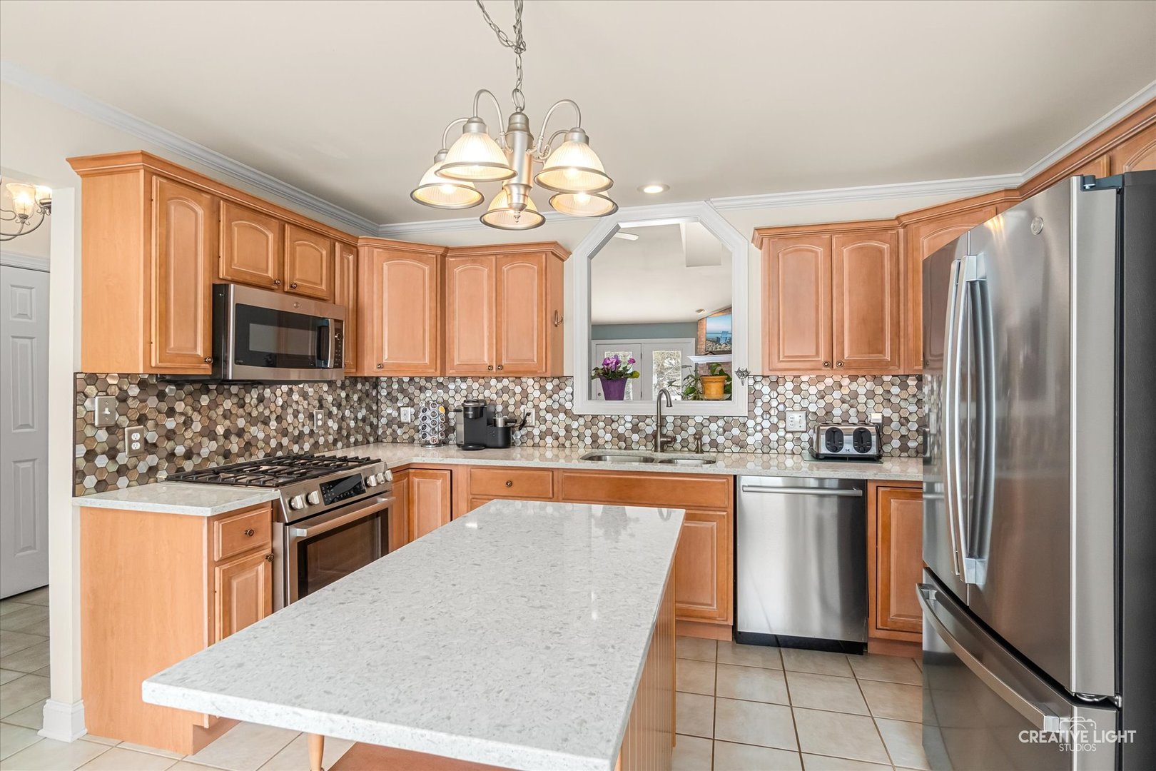 3160 Covered Bridge Lane DeKalb, IL 60115 - Photo 7 of 28 a kitchen with stainless steel appliances granite countertop a sink stove and refrigerator