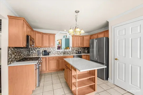 a kitchen with stainless steel appliances a stove a refrigerator and a sink