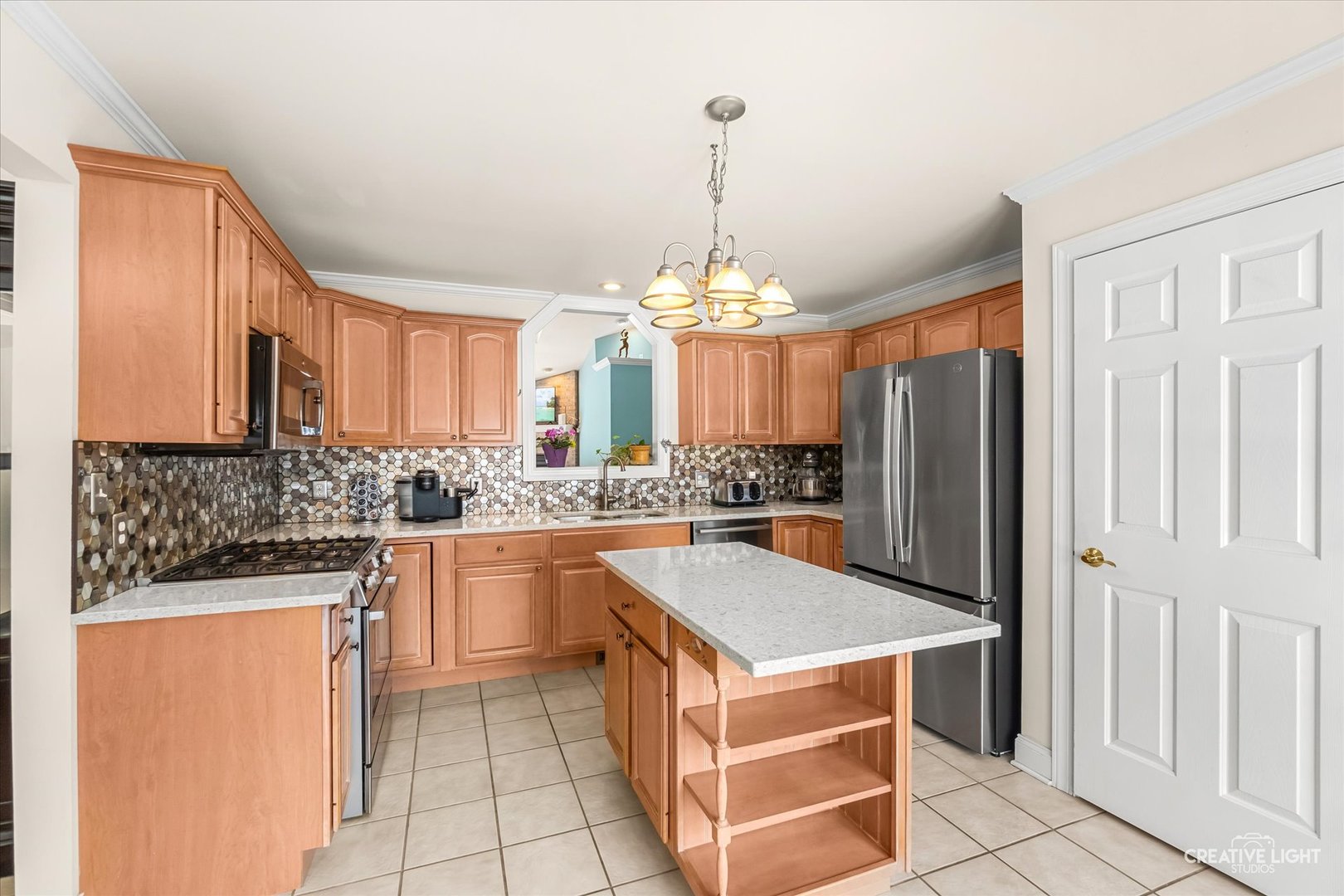 3160 Covered Bridge Lane DeKalb, IL 60115 - Photo 8 of 28 a kitchen with stainless steel appliances a stove a refrigerator and a sink