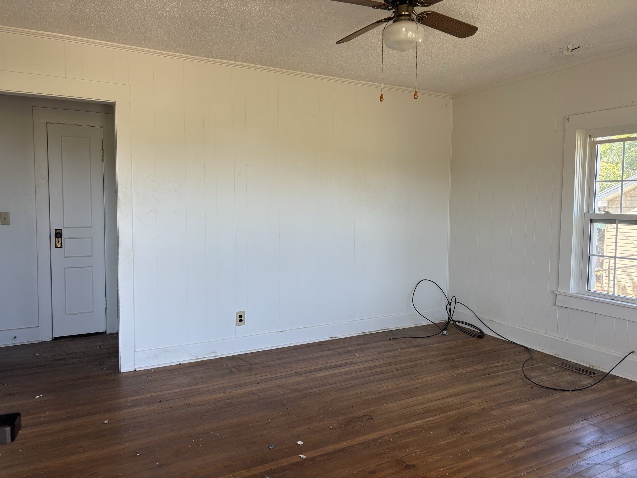104 General Avenue Centerville, TN 37033 - Photo 2 of 11 an empty room with wooden floor fan and windows