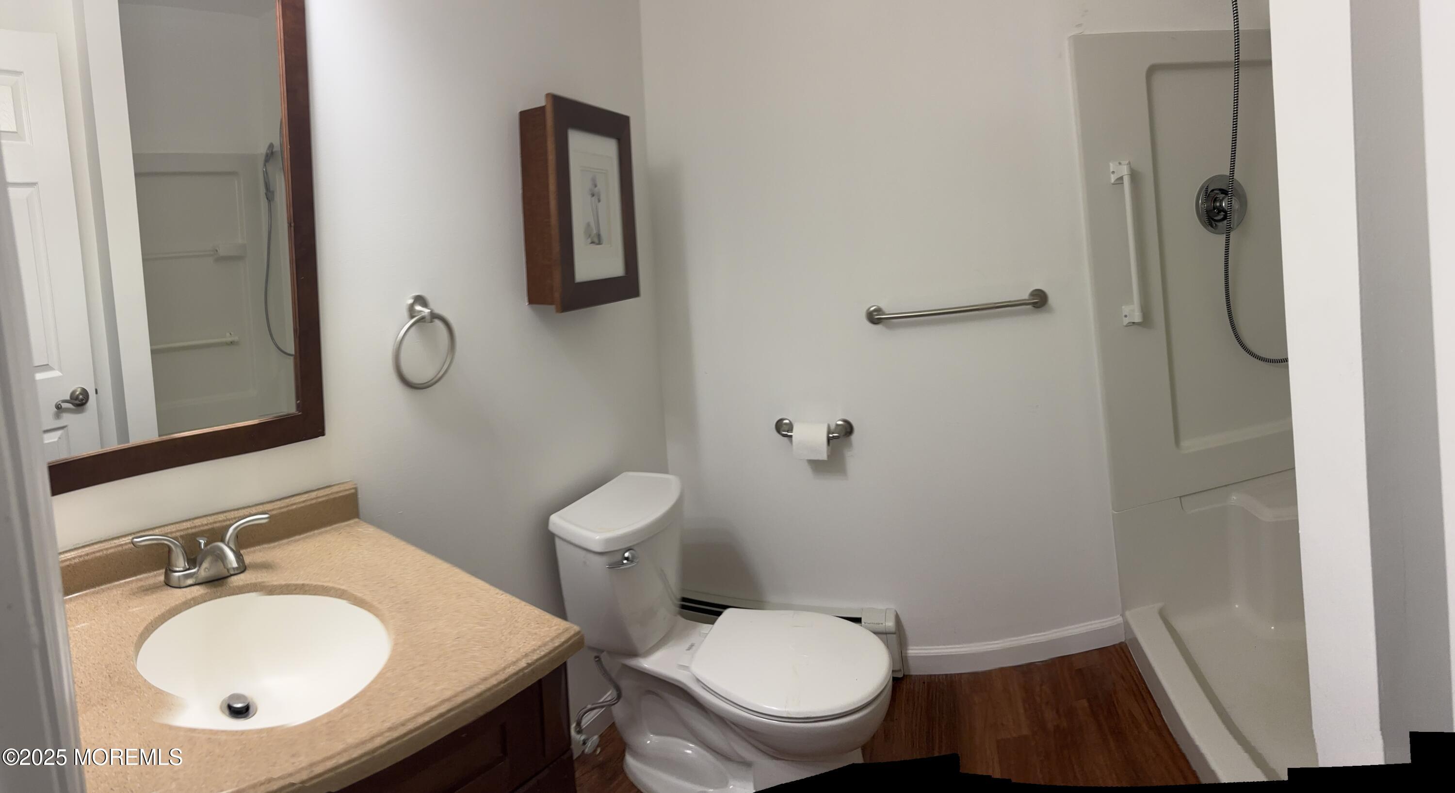 12 Dawn Way Toms River, NJ 08757 - Photo 11 of 19 a bathroom with a toilet a sink and mirror