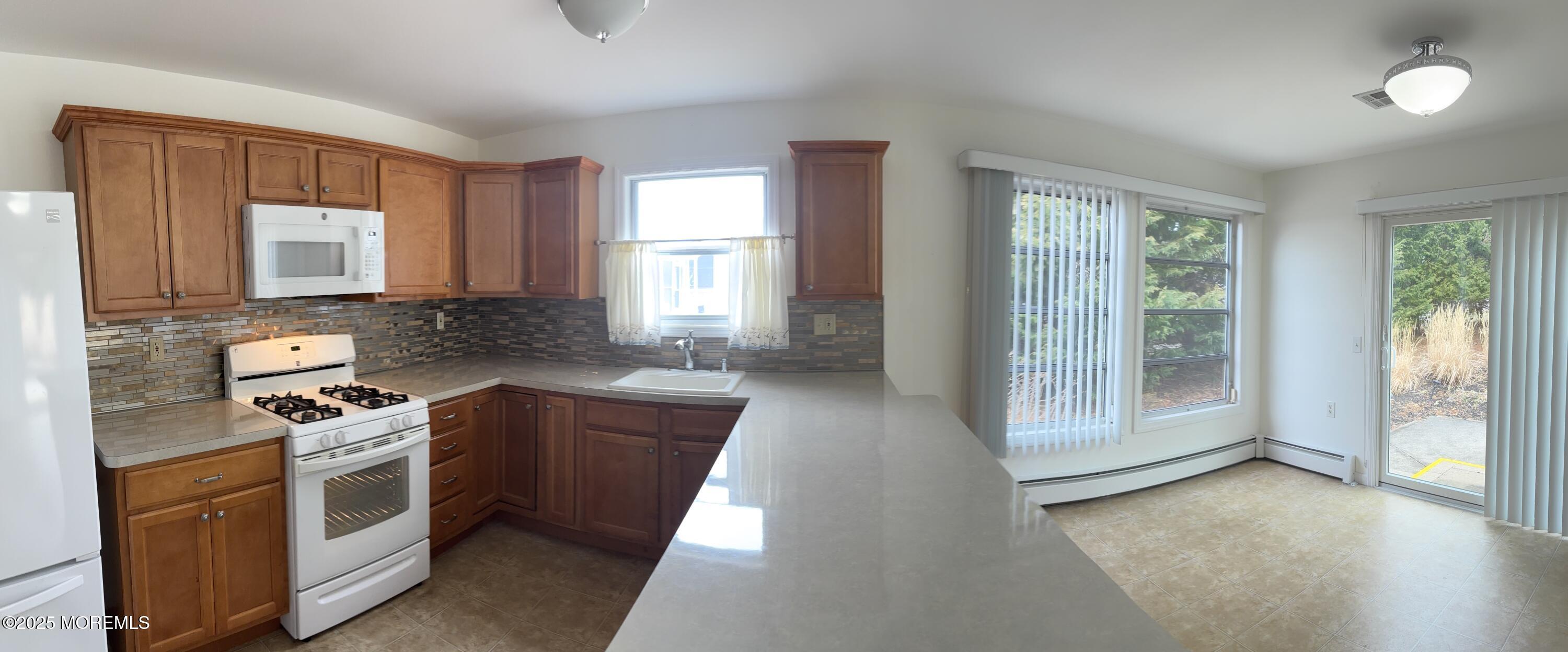 12 Dawn Way Toms River, NJ 08757 - Photo 6 of 19 a kitchen with stainless steel appliances granite countertop a stove a sink and a refrigerator
