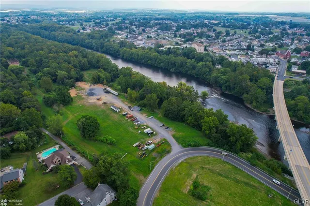 an aerial view of a house with a garden and lake view