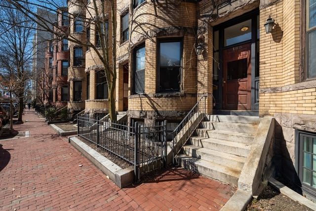 a view of a street that has couple of cars parked on the road