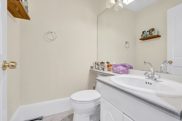 a bathroom with a sink mirror vanity and toilet