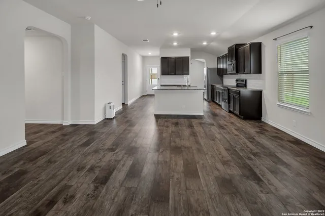 a view of kitchen with refrigerator microwave and oven