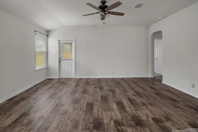 wooden floor in an empty room with a window