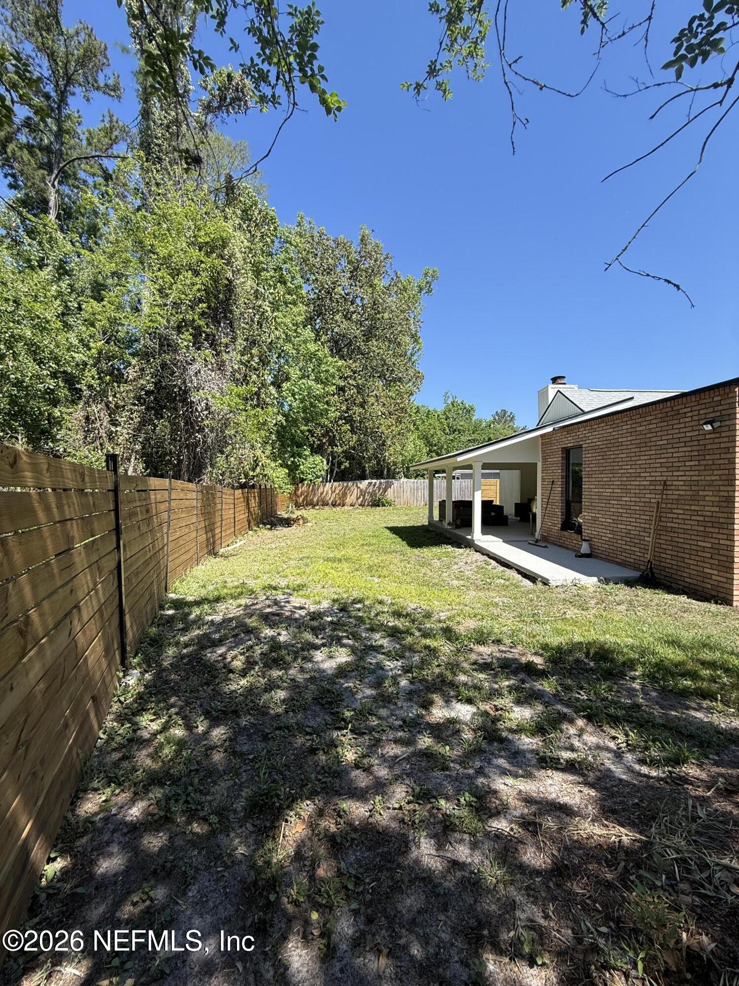 8618 Boxberry Lane Jacksonville, FL 32244 - Photo 15 of 18 a backyard of a house with lots of green space