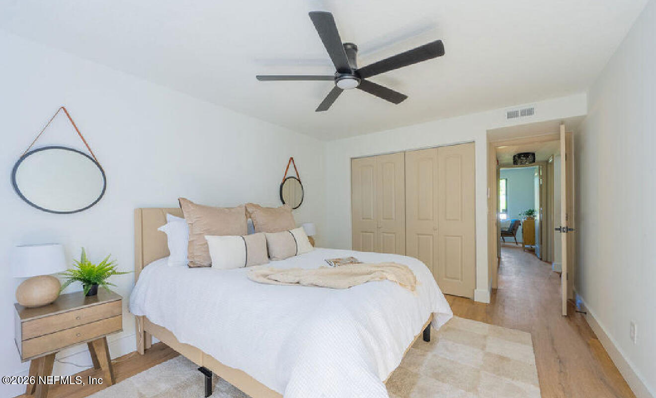 8618 Boxberry Lane Jacksonville, FL 32244 - Photo 10 of 18 a bedroom with a bed and a chandelier