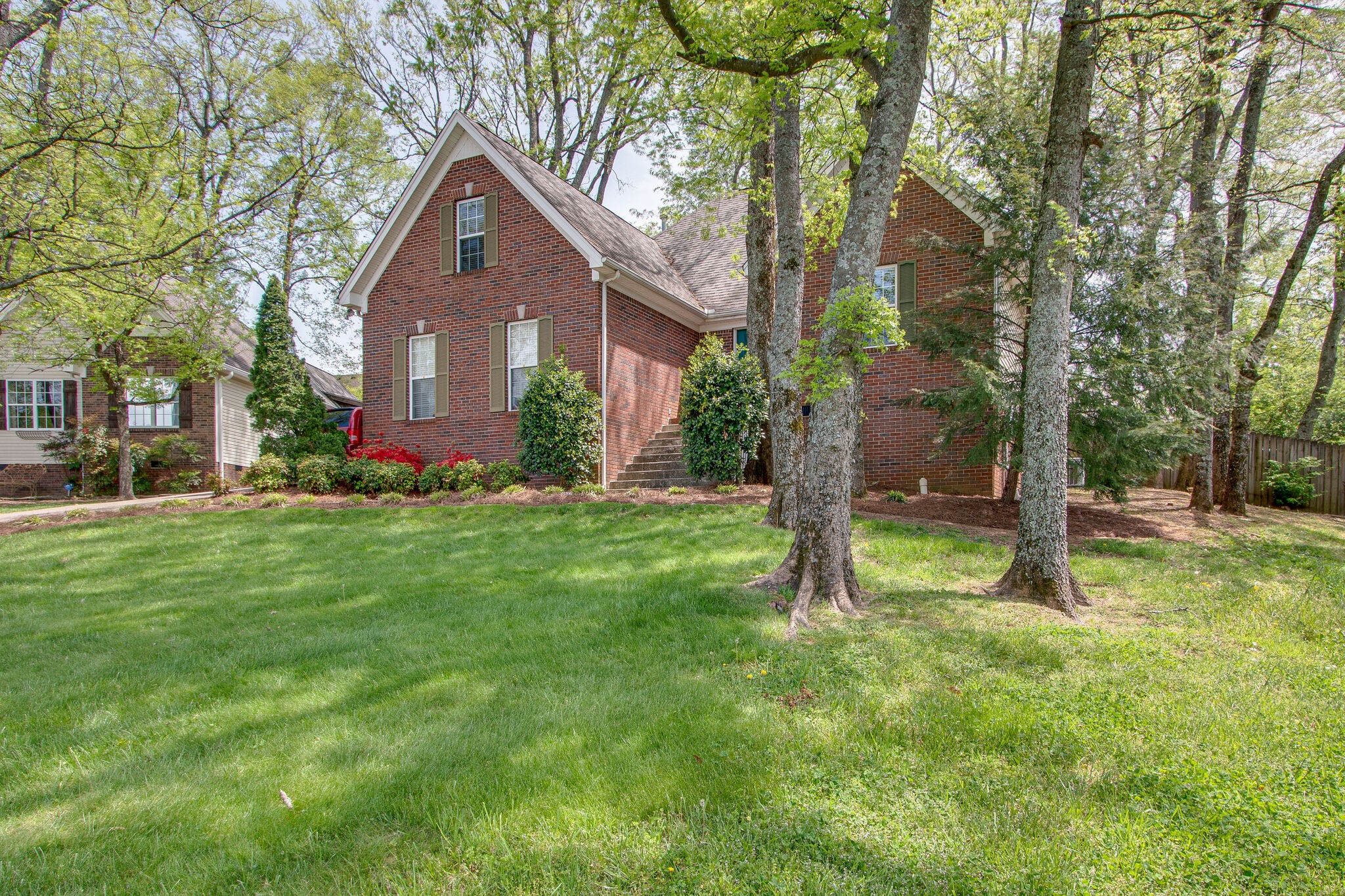 a front view of house with yard and green space