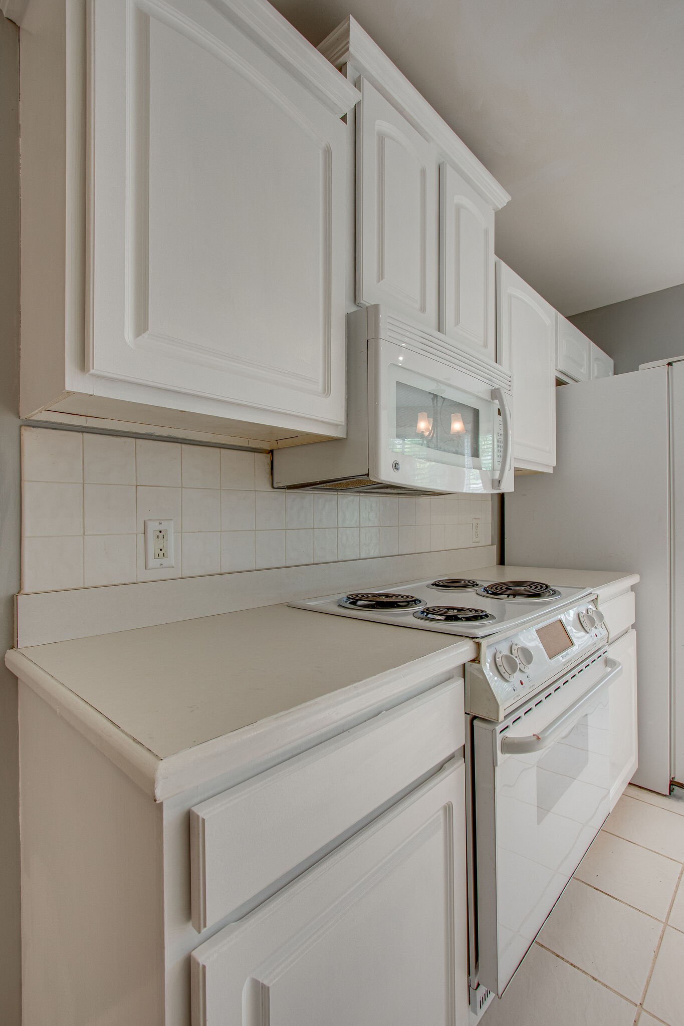 1615 Pacer Court Spring Hill, TN 37174 - Photo 13 of 30 a kitchen with white cabinets and white appliances