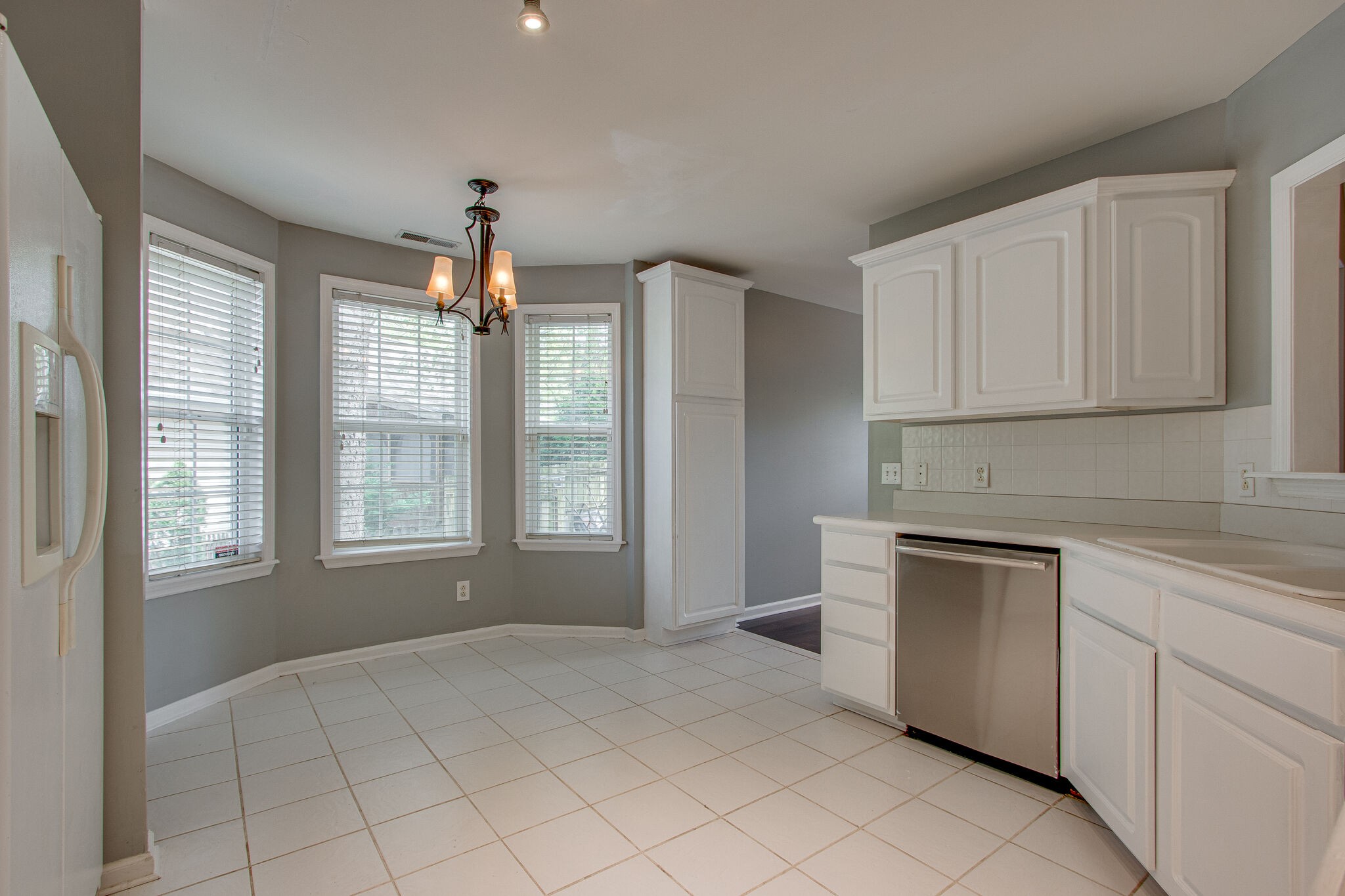 1615 Pacer Court Spring Hill, TN 37174 - Photo 14 of 30 a kitchen with granite countertop white cabinets and white appliances