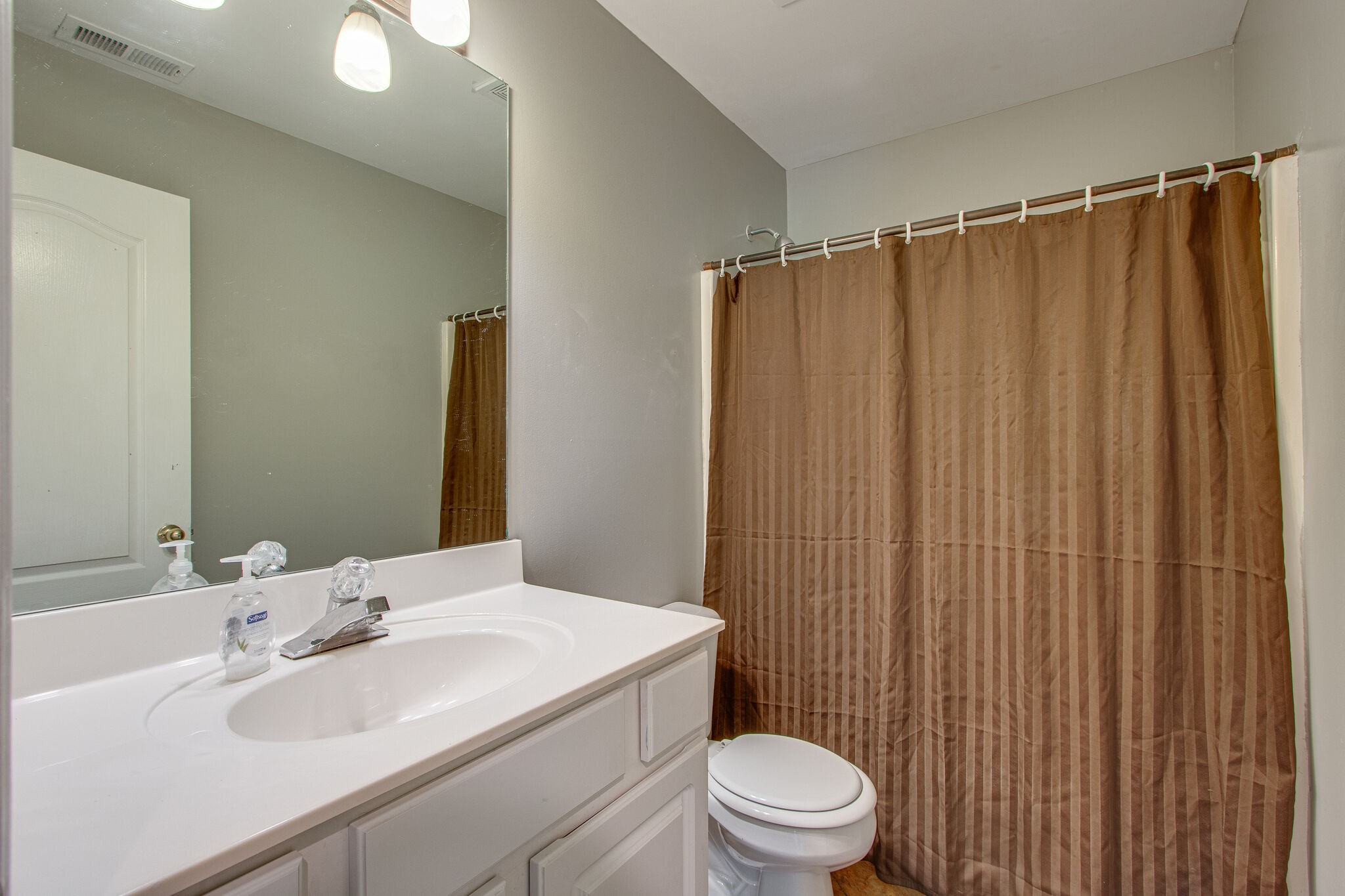1615 Pacer Court Spring Hill, TN 37174 - Photo 25 of 30 a bathroom with a sink a toilet and shower
