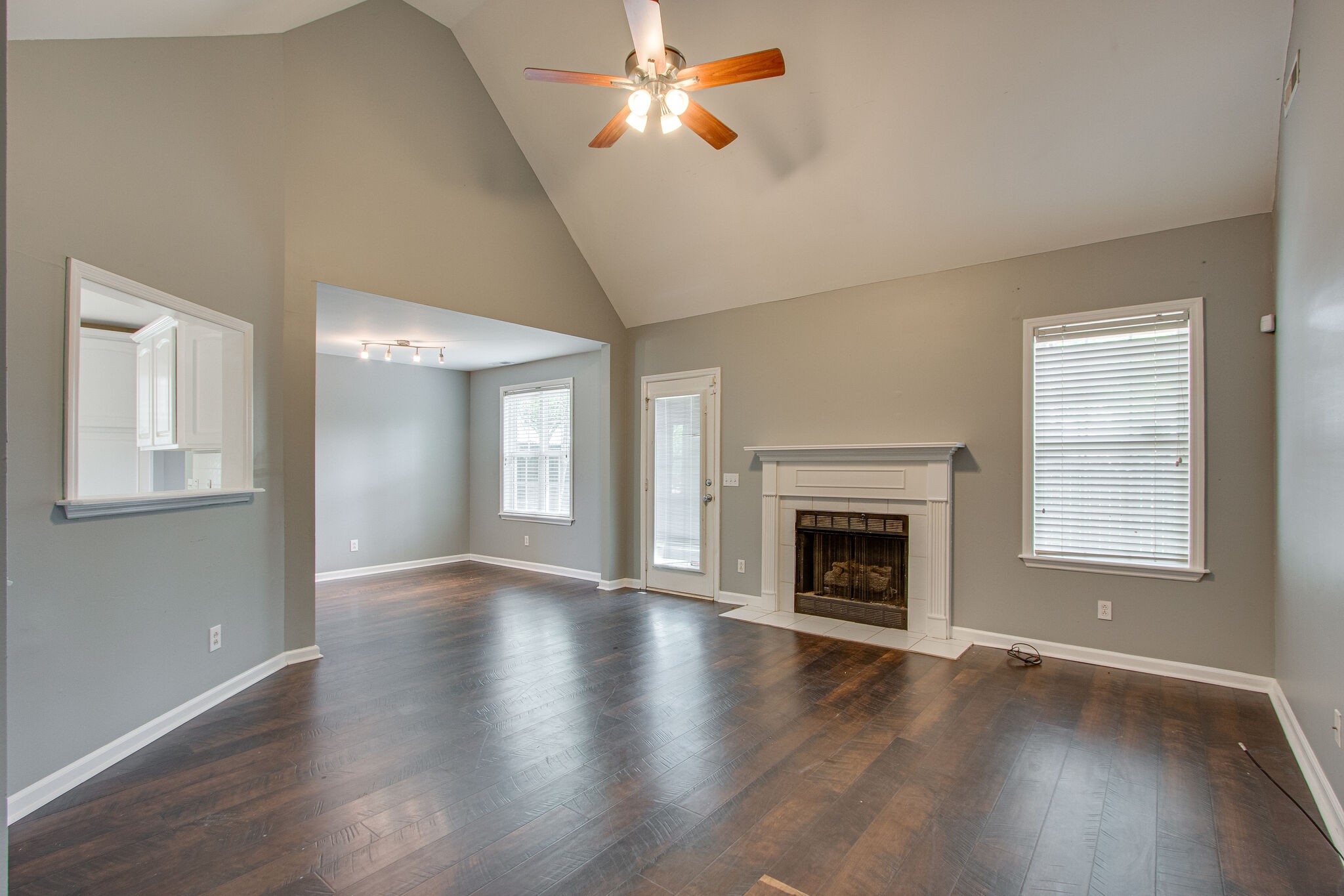 1615 Pacer Court Spring Hill, TN 37174 - Photo 5 of 30 an empty room with wooden floor fireplace and windows