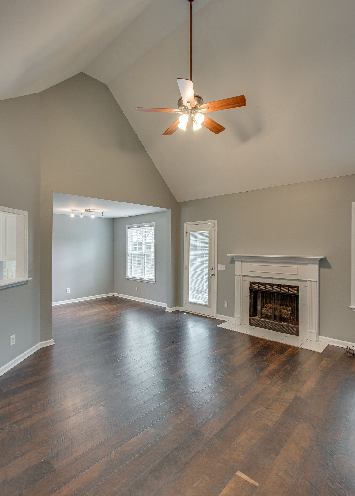 1615 Pacer Court Spring Hill, TN 37174 - Photo 6 of 30 an empty room with wooden floor fireplace cabinet and windows