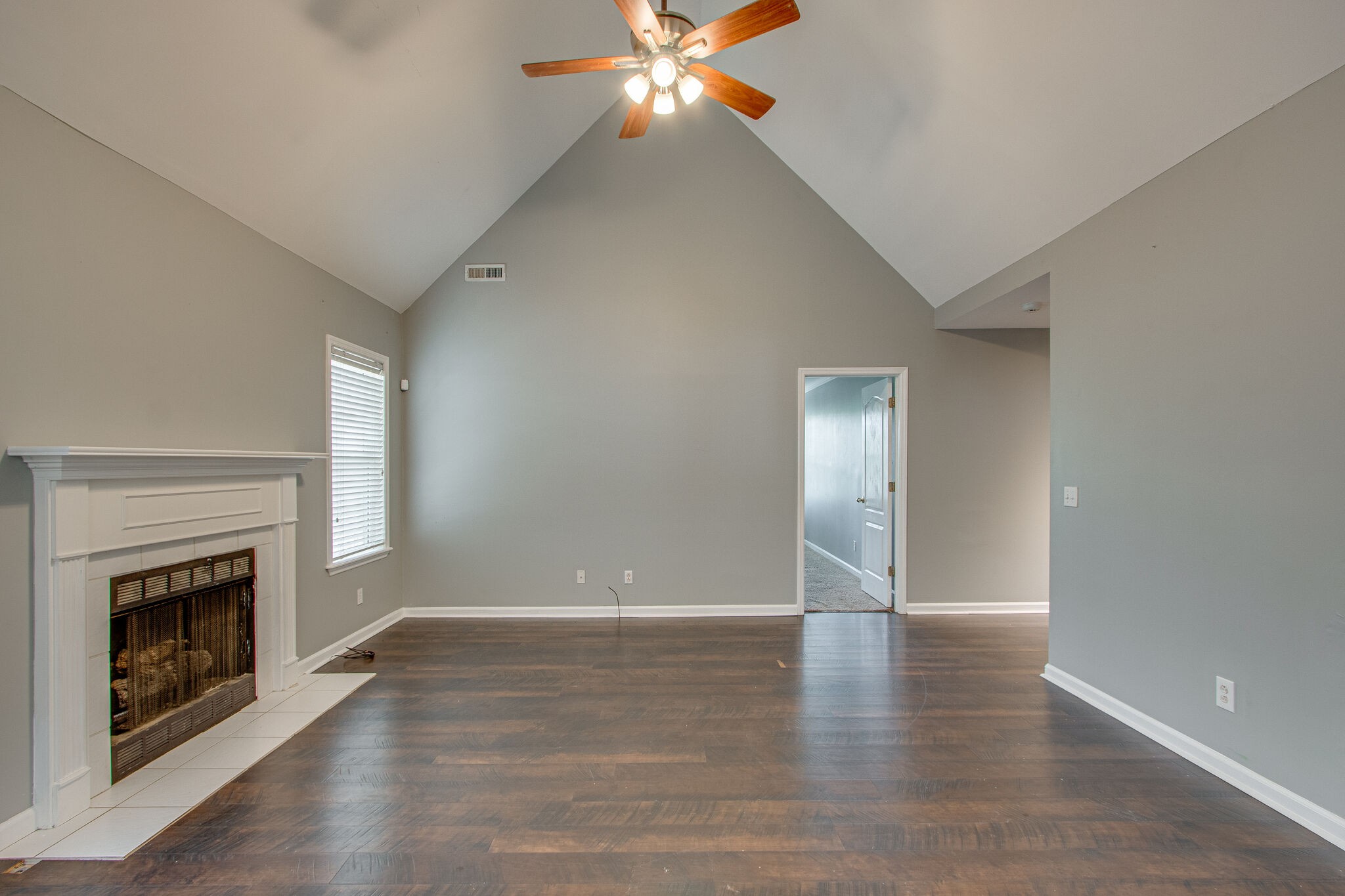 1615 Pacer Court Spring Hill, TN 37174 - Photo 7 of 30 an empty room with wooden floor fireplace and windows