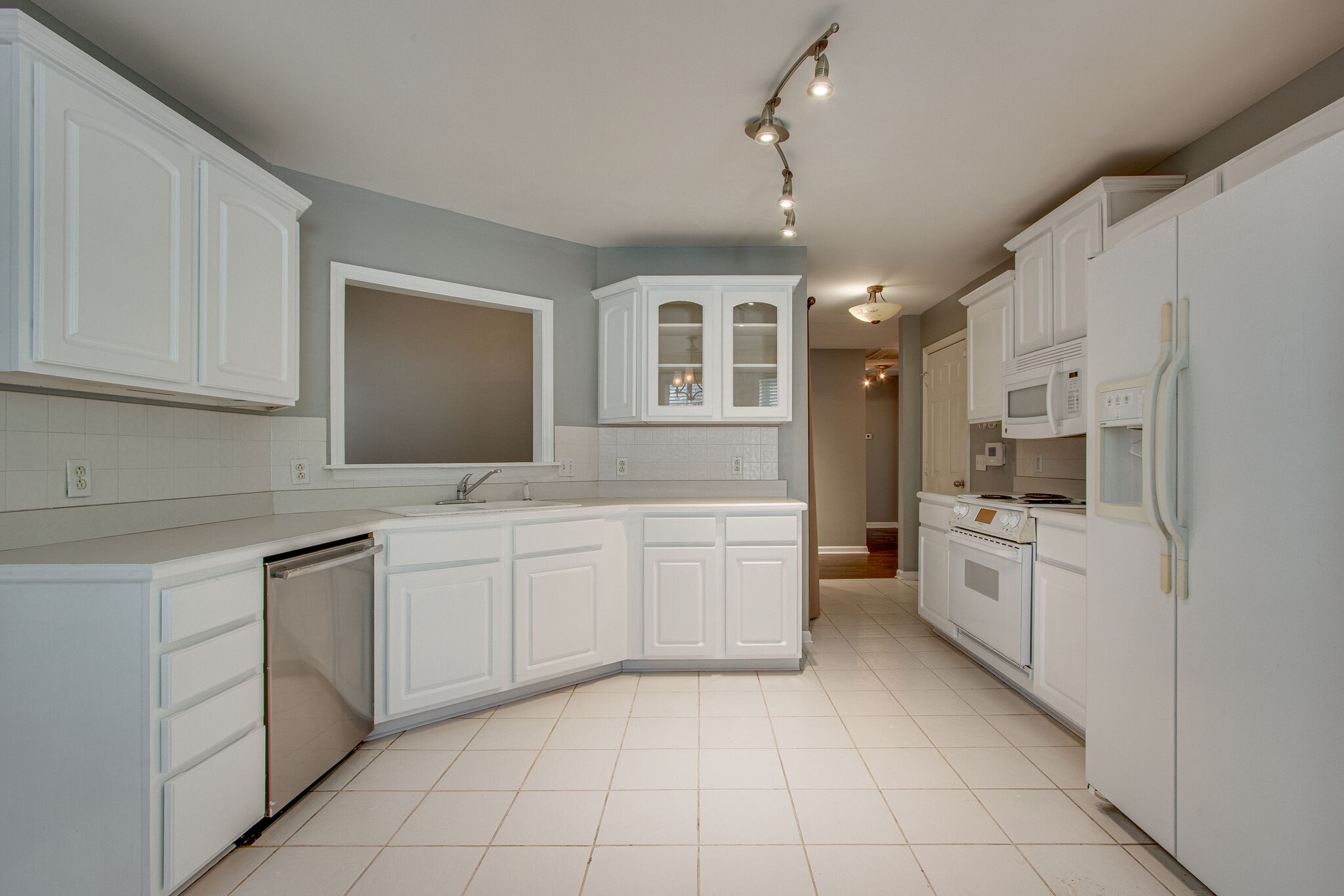 1615 Pacer Court Spring Hill, TN 37174 - Photo 9 of 30 a kitchen with white cabinets appliances and sink