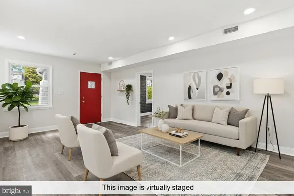 a living room with furniture and a potted plant