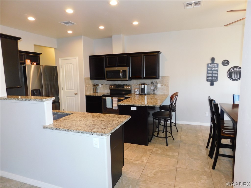 3370 South Ridge Avenue Bullhead City, AZ 86429 - Photo 27 of 56 a large kitchen with a table and chairs