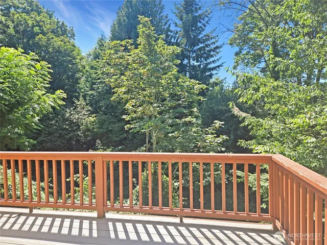 a view of balcony with wooden floor and fence