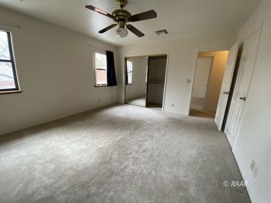 717 North Inyo Street Ridgecrest, CA 93555 - Photo 15 of 26 a view of a big room with windows and chandelier fan