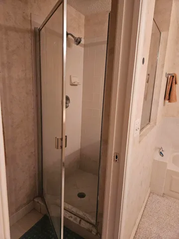 a bathroom with a glass shower door