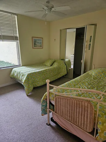 a bedroom with two beds and window