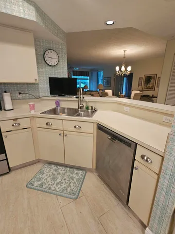 a kitchen with a sink cabinets and appliances