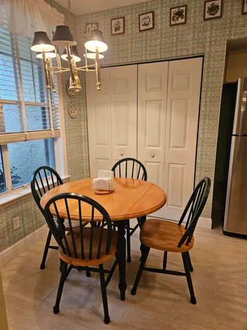 a view of a dining room with furniture and chandelier