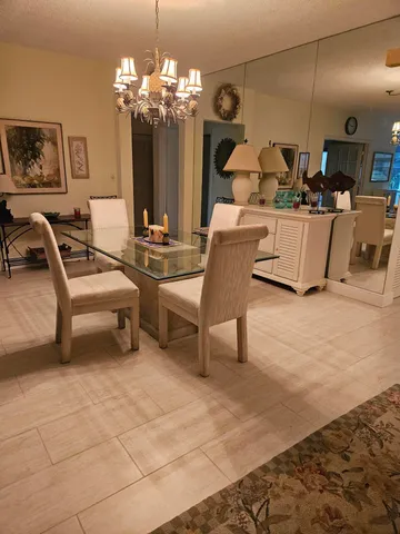 a living room with lots of furniture and chandelier