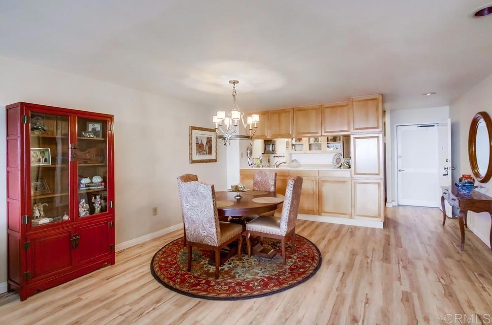 2500 Torrey Pines Road, Unit 802 La Jolla, CA 92037 - Photo 11 of 40 a view of a dining room with furniture window and wooden floor