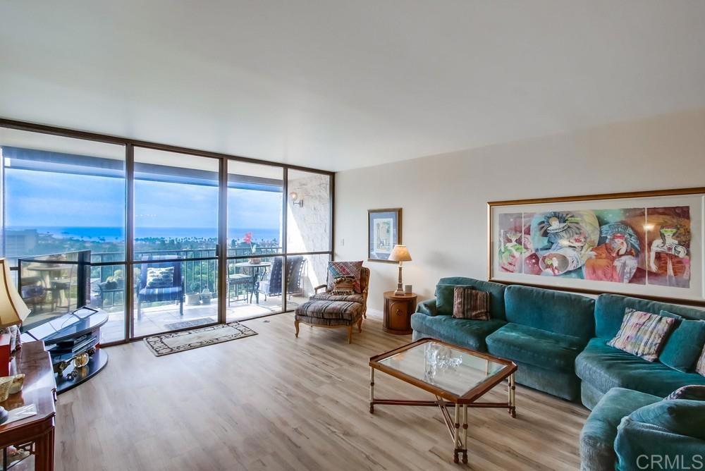 2500 Torrey Pines Road, Unit 802 La Jolla, CA 92037 - Photo 2 of 40 a living room with furniture and a floor to ceiling window