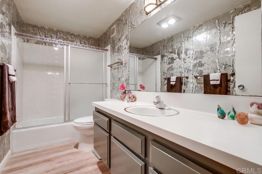 2500 Torrey Pines Road, Unit 802 La Jolla, CA 92037 - Photo 24 of 40 a bathroom with a sink a mirror and a shower