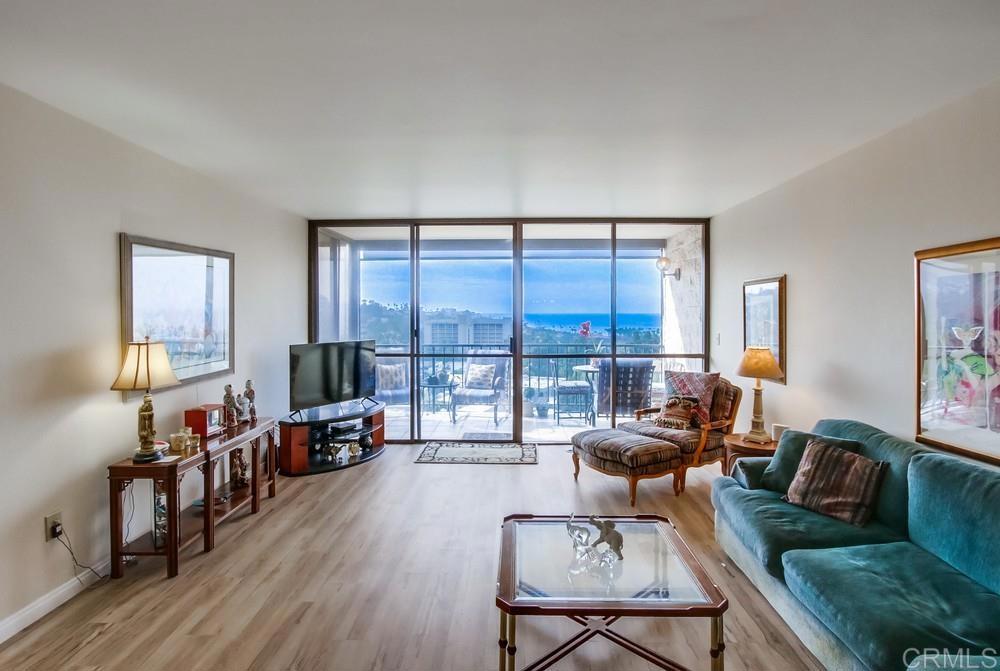 2500 Torrey Pines Road, Unit 802 La Jolla, CA 92037 - Photo 5 of 40 a living room with furniture and a flat screen tv with wooden floor