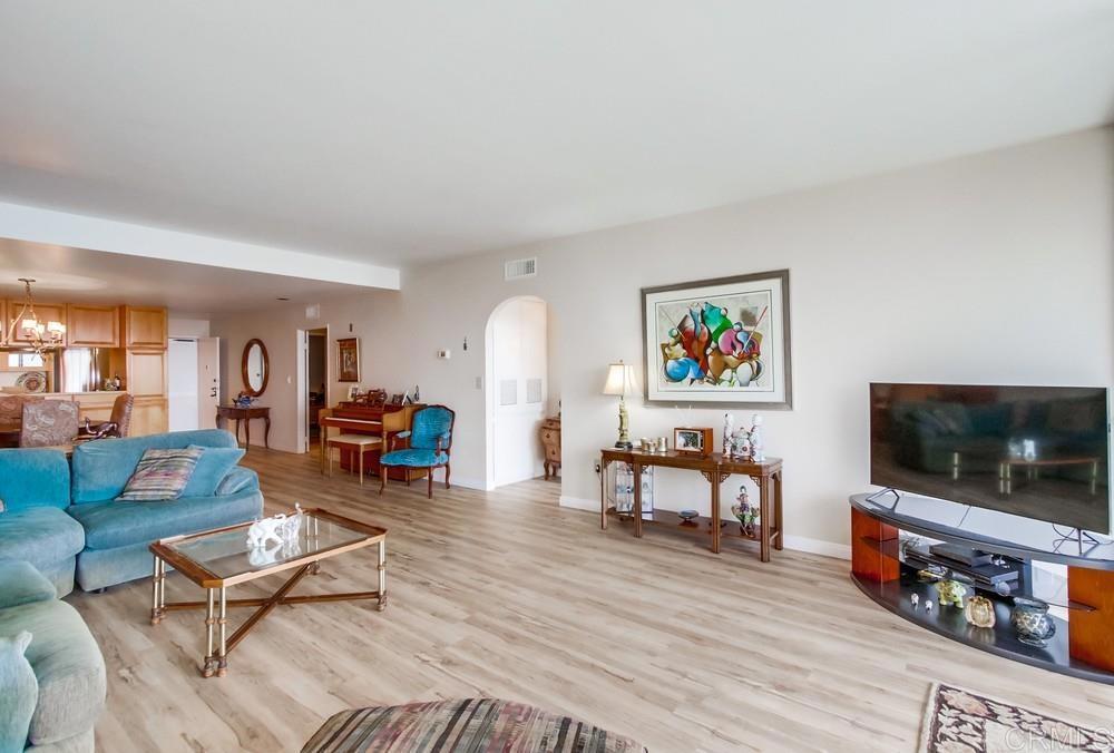 2500 Torrey Pines Road, Unit 802 La Jolla, CA 92037 - Photo 9 of 40 a living room with furniture and a flat screen tv