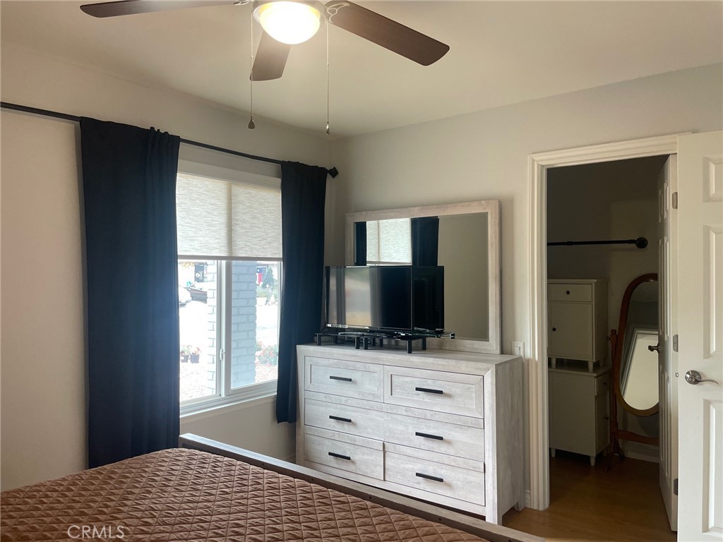 26592 Farrell Street Menifee, CA 92586 - Photo 16 of 31 a bedroom with a bed and a flat tv screen in it