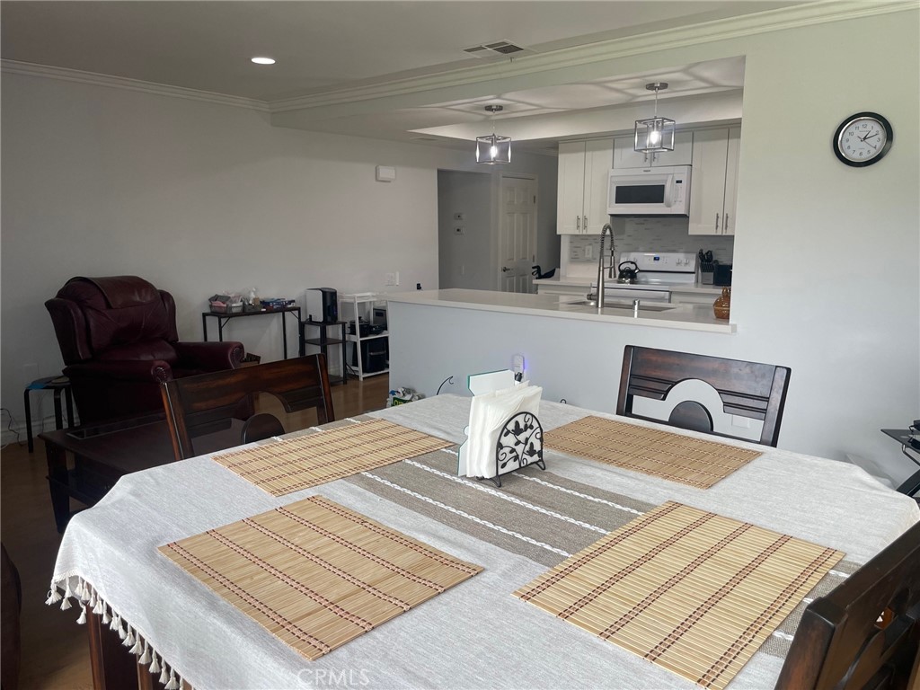 26592 Farrell Street Menifee, CA 92586 - Photo 19 of 31 a kitchen with a table chairs and a kitchen