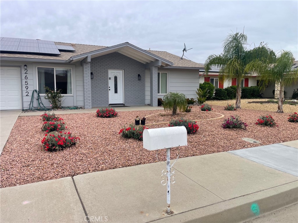 26592 Farrell Street Menifee, CA 92586 - Photo 2 of 31 a view of a backyard with a patio table and chairs