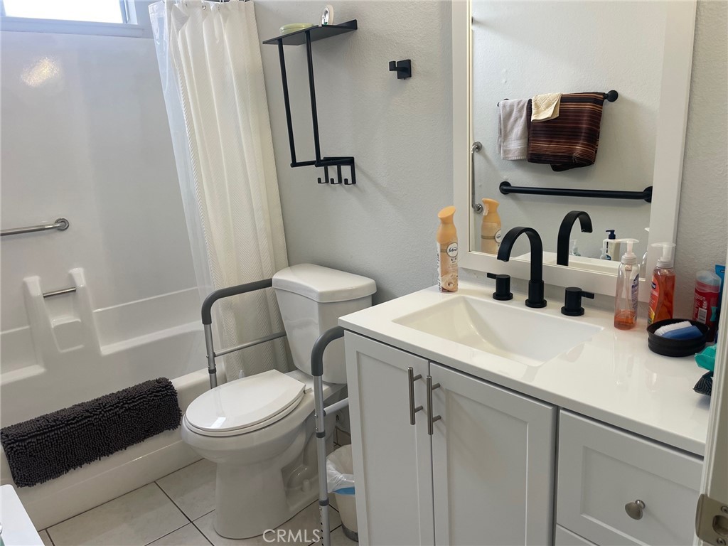 26592 Farrell Street Menifee, CA 92586 - Photo 24 of 31 a bathroom with a toilet sink and mirror